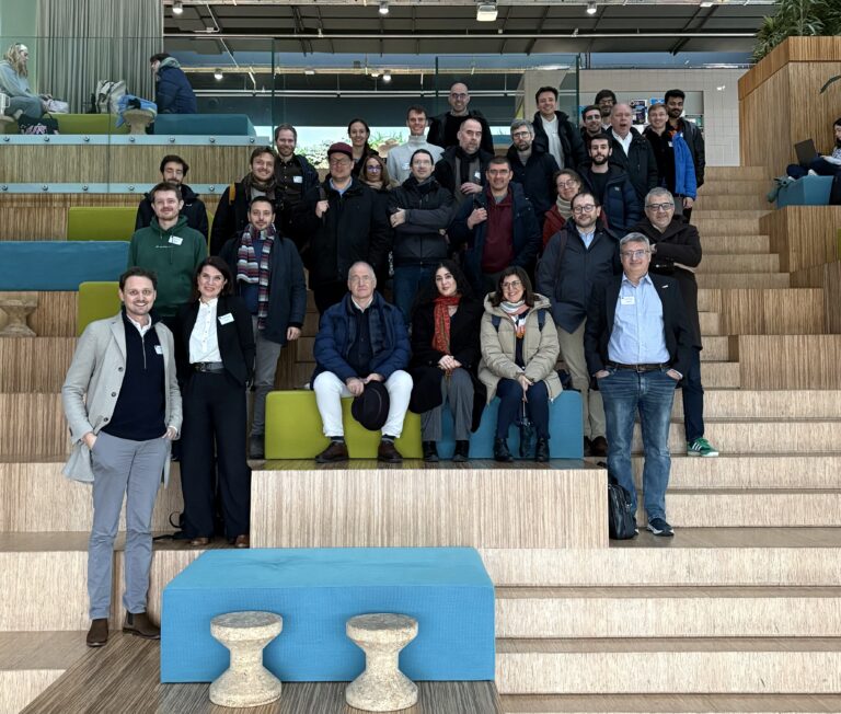 image of representatives from different EIC portfolio projects at the entrance of the meeting